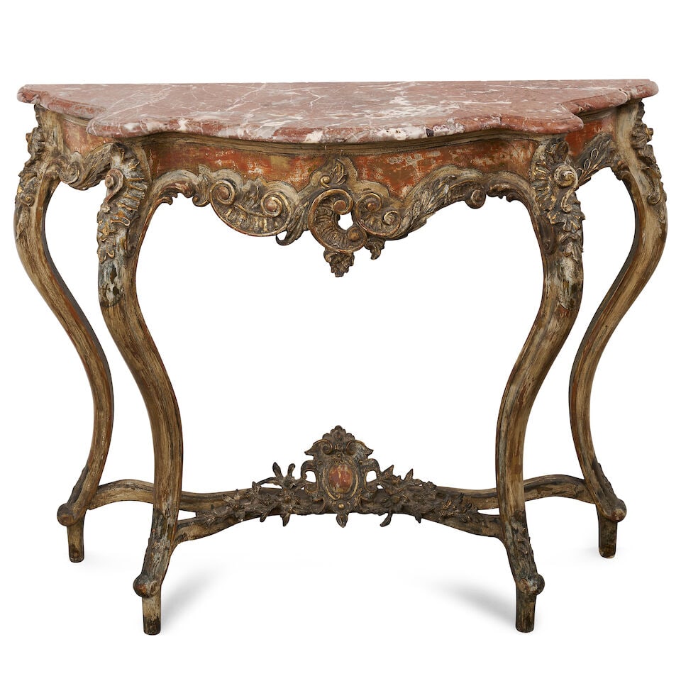 A French giltwood Louis XV style console table,: A French giltwood Louis XV style console table, with serpentine rouge marble top, above a foliate carved apron raised on cabriole legs, joined by X stretcher, centred by a carved cartouche, height: 89