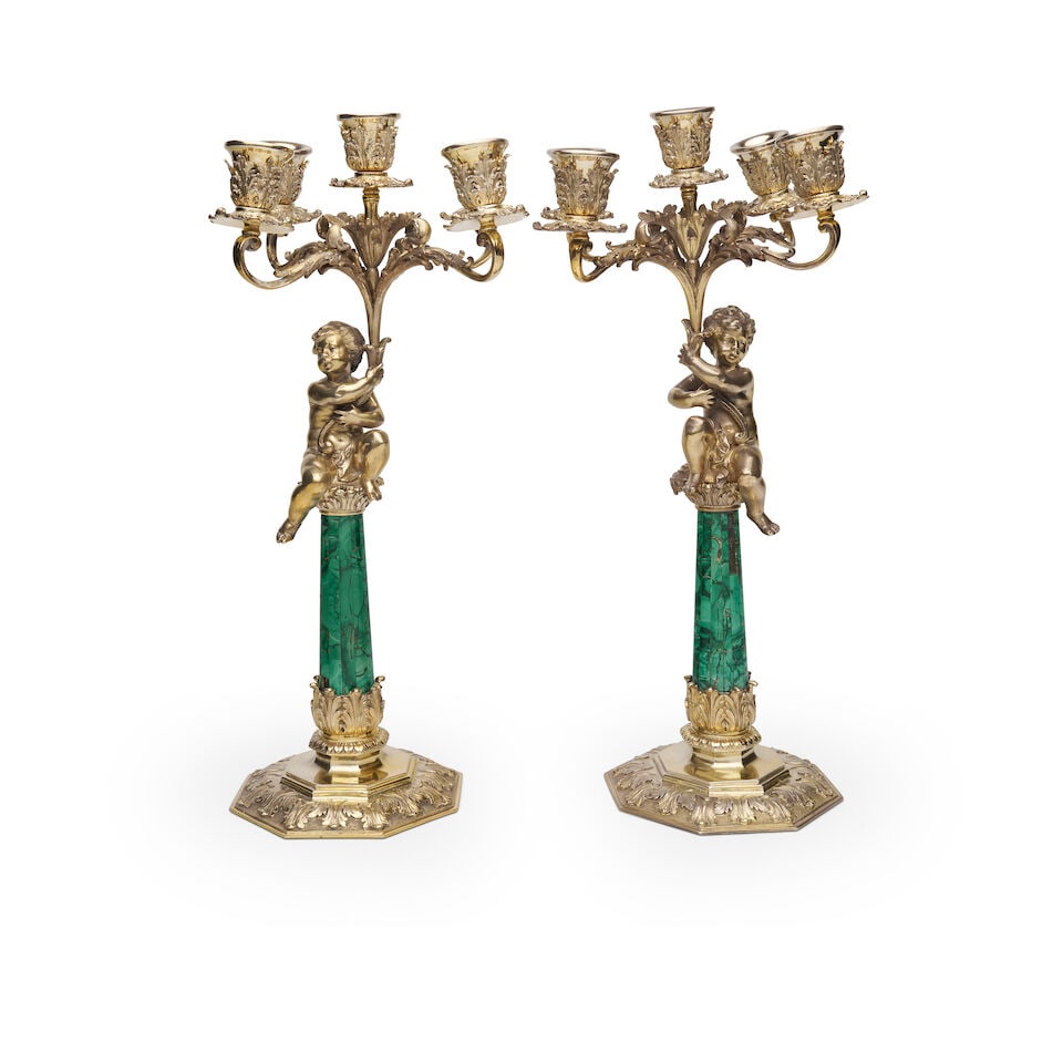Asprey | A pair of malachite and gilt candelabra Asprey & Co. Ltd. London, import marks, 1959,: Asprey | A pair of malachite and gilt candelabra Asprey & Co. Ltd. London, import marks, 1959, Each five-cup candelabra with tapering malachite column surmounted by putti, acanthus and scroll