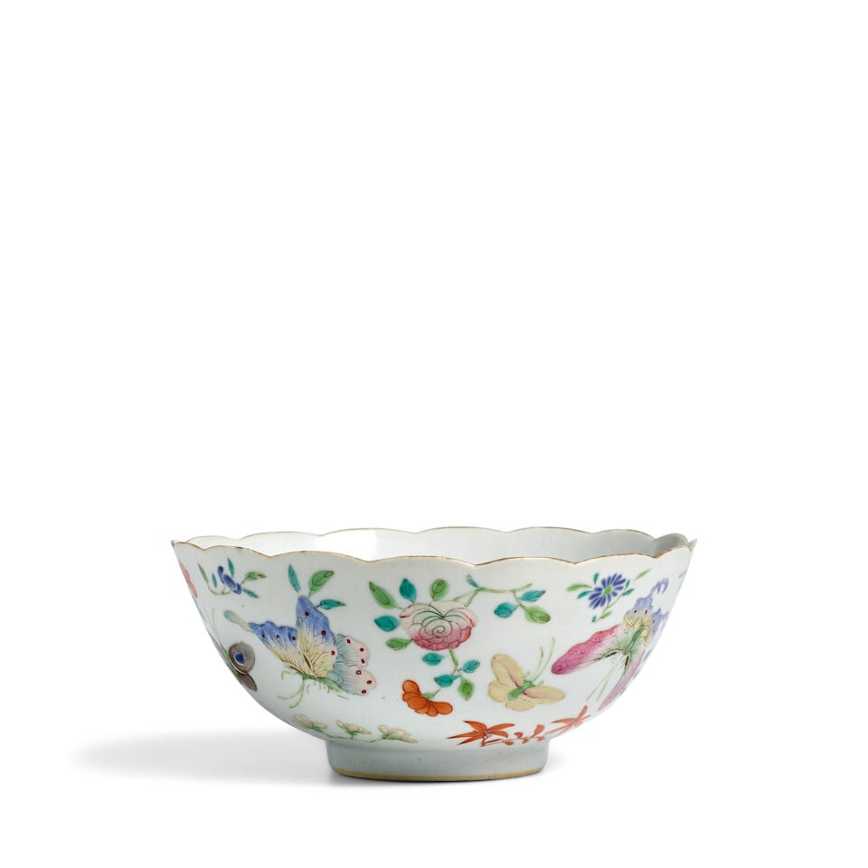 A GILT-RIMMED FAMILLE-ROSE 'BUTTERFLIES AND FLOWER' BOWL Jiaqing mark, 19th century: A GILT-RIMMED FAMILLE-ROSE 'BUTTERFLIES AND FLOWER' BOWL Jiaqing mark, 19th century The interior painted with sprays of melons, the base with a six-character Jiaqing mark in iron-red. 6 7/8in (17.5cm)