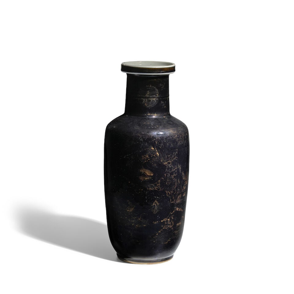 A BLACK-GROUND GILT-DECORATED 'LANDSCAPE' ROULEAU VASE Kangxi period: A BLACK-GROUND GILT-DECORATED 'LANDSCAPE' ROULEAU VASE Kangxi period 17 1/2in (44.5cm) high Footnotes: 清康熙