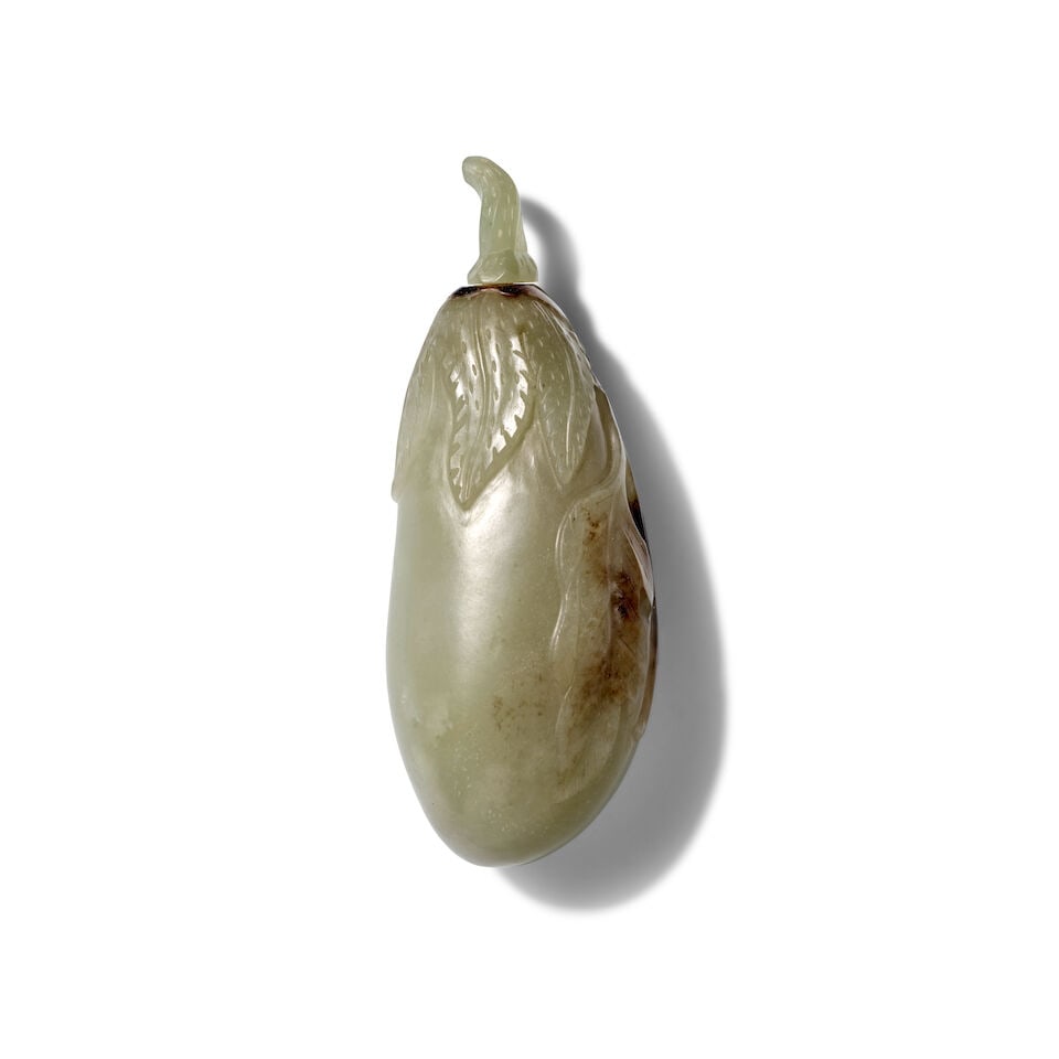 A GRAYISH-WHITE JADE 'EGGPLANT' SNUFF BOTTLE: A GRAYISH-WHITE JADE 'EGGPLANT' SNUFF BOTTLE 3in (7.7cm) high, stopper Footnotes: 灰白玉帶皮茄型鼻煙壺一件 For further
