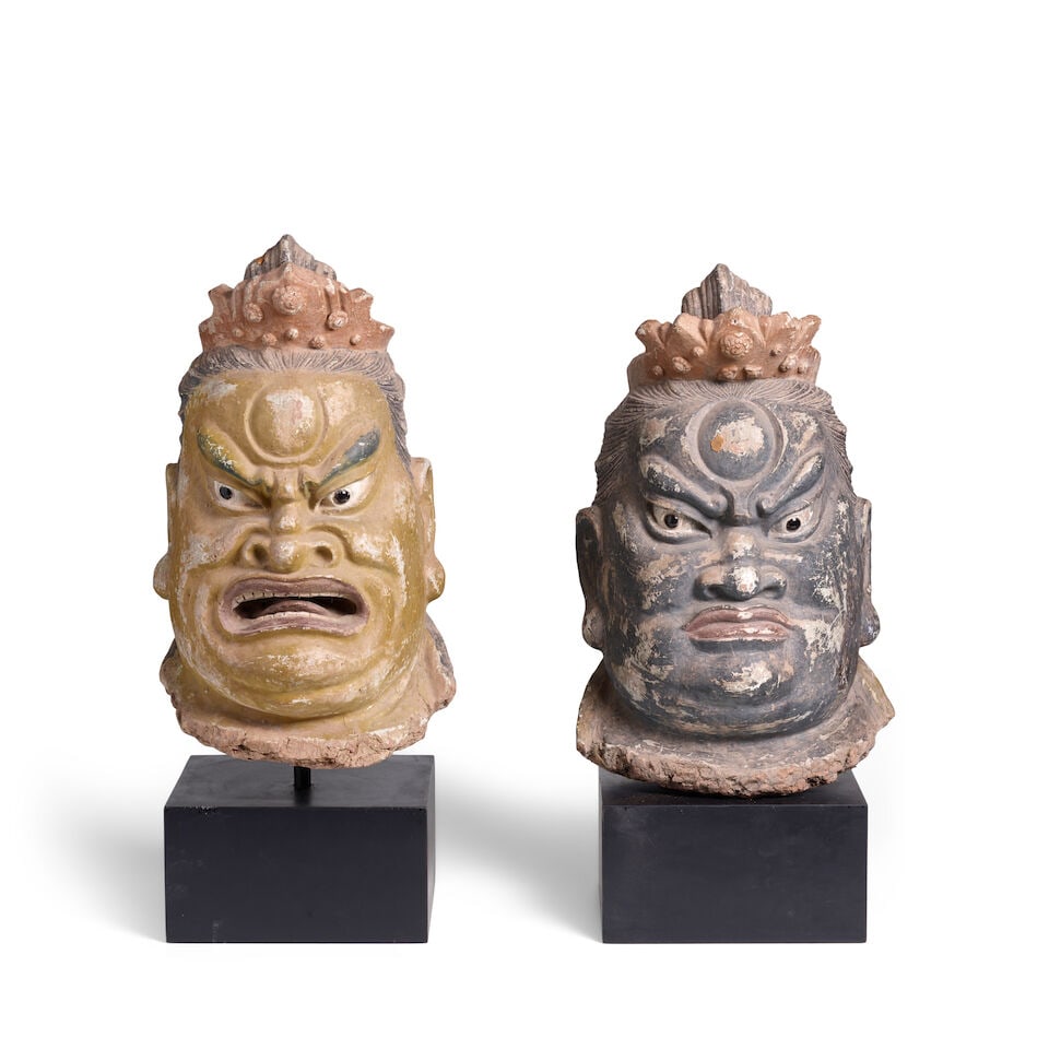 TWO LARGE POLYCHROME STUCCO HEADS OF BUDDHIST GUARDIANS Ming Dynasty (2): TWO LARGE POLYCHROME STUCCO HEADS OF BUDDHIST GUARDIANS Ming Dynasty 19 5/16in (49cm) each (2). Footnotes: 明 彩塑天王首像一對 Provenance: New