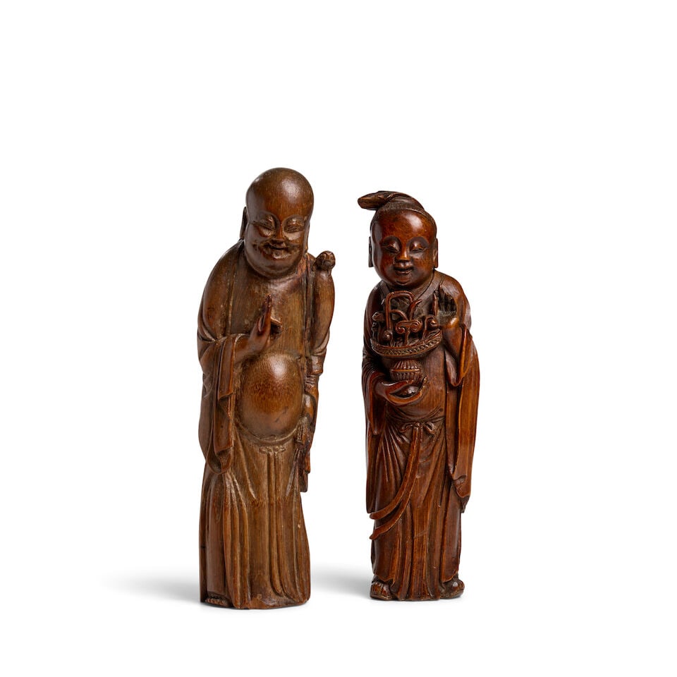 TWO BAMBOO ROOT CARVINGS OF DAOIST IMMORTALS, LAN CAIHE AND LIU HAI Qing Dynasty (2): TWO BAMBOO ROOT CARVINGS OF DAOIST IMMORTALS, LAN CAIHE AND LIU HAI Qing Dynasty 8 1/8 and 8 3/8in (20.6 and 21.2cm) high (2). Footnotes: 清 竹根雕道教神Ķ