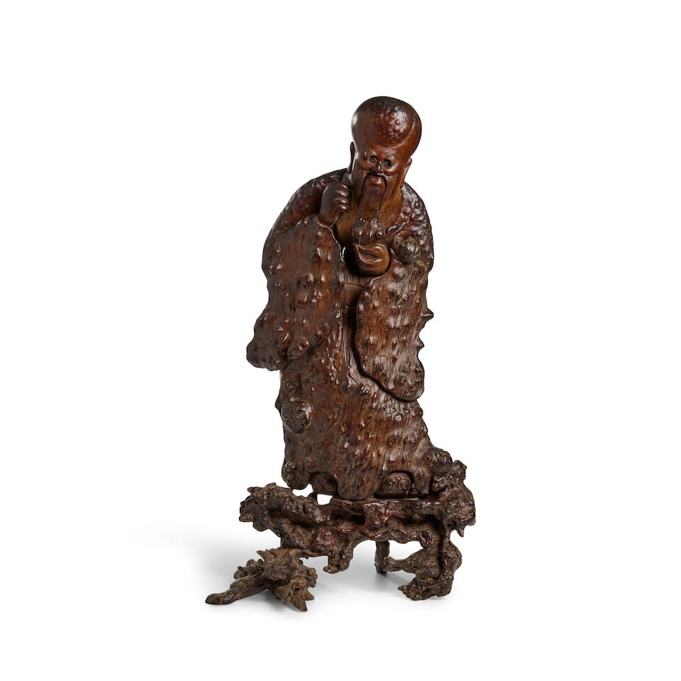 A LARGE BURLWOOD CARVED FIGURE OF SHOULAO ON STAND Late Qing Dynasty: A LARGE BURLWOOD CARVED FIGURE OF SHOULAO ON STAND Late Qing Dynasty 30 1/4in (76.8cm) high Footnotes: 晚清 癭木雕壽老帶座立像 For