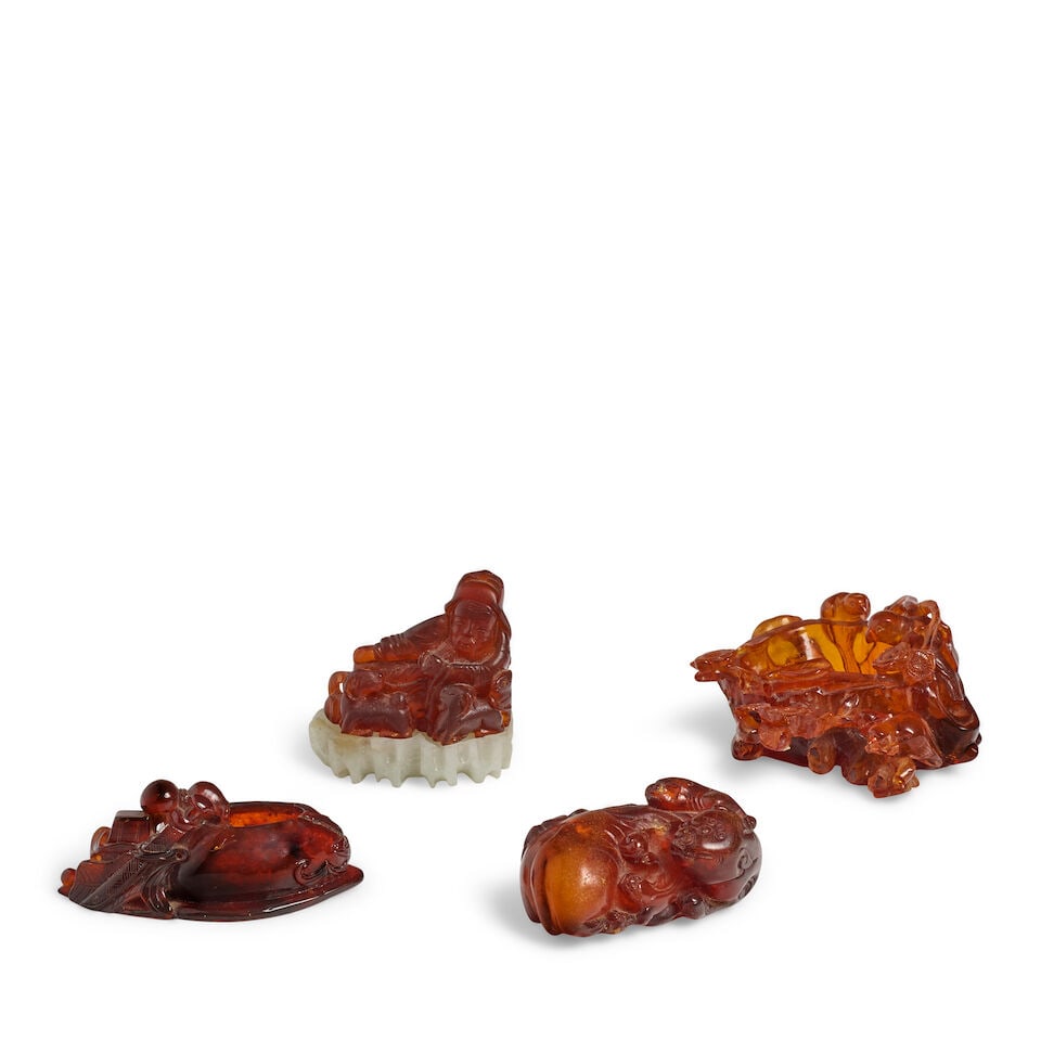A GROUP OF FOUR AMBER CARVINGS 19th century (4, fitted hardstone stand for the Su Wu carving) (1 of 2)