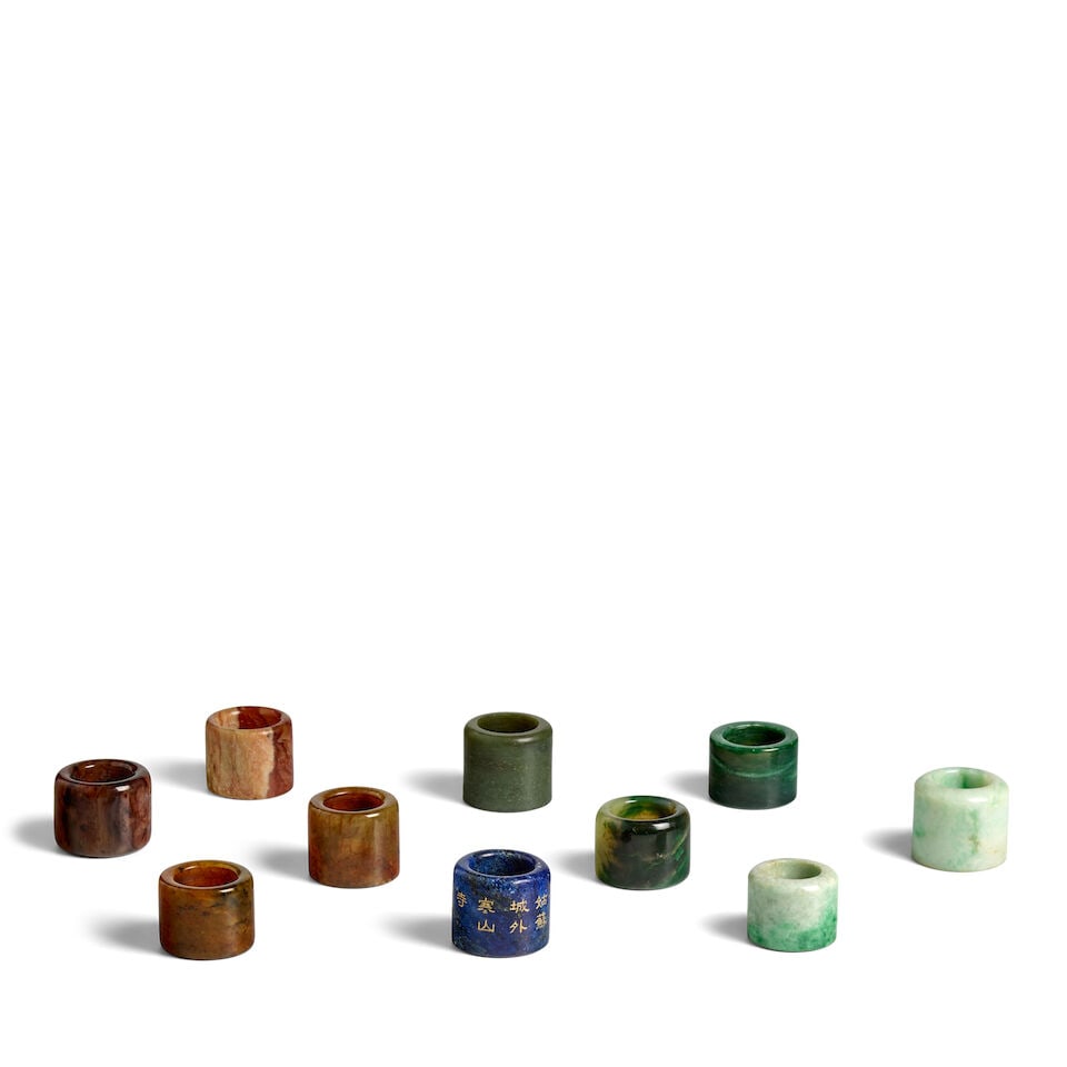 A GROUP OF TEN JADE AND HARDSTONE ARCHER'S RINGS 20th century (10) (1 of 1)