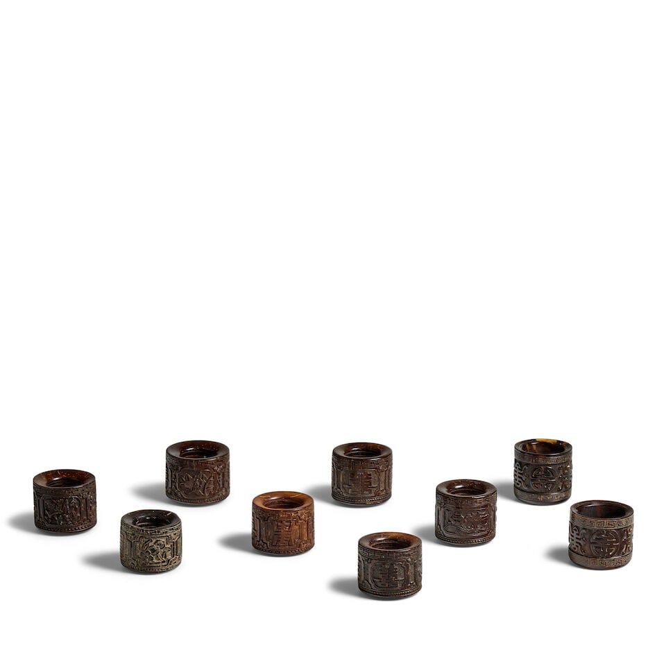 A GROUP OF NINE COCONUT SHELL ARCHER'S RINGS 20th century (9): A GROUP OF NINE COCONUT SHELL ARCHER'S RINGS 20th century 1in (2.5cm) to 1 1/4in (3.2cm) (9). Footnotes: 二十世紀