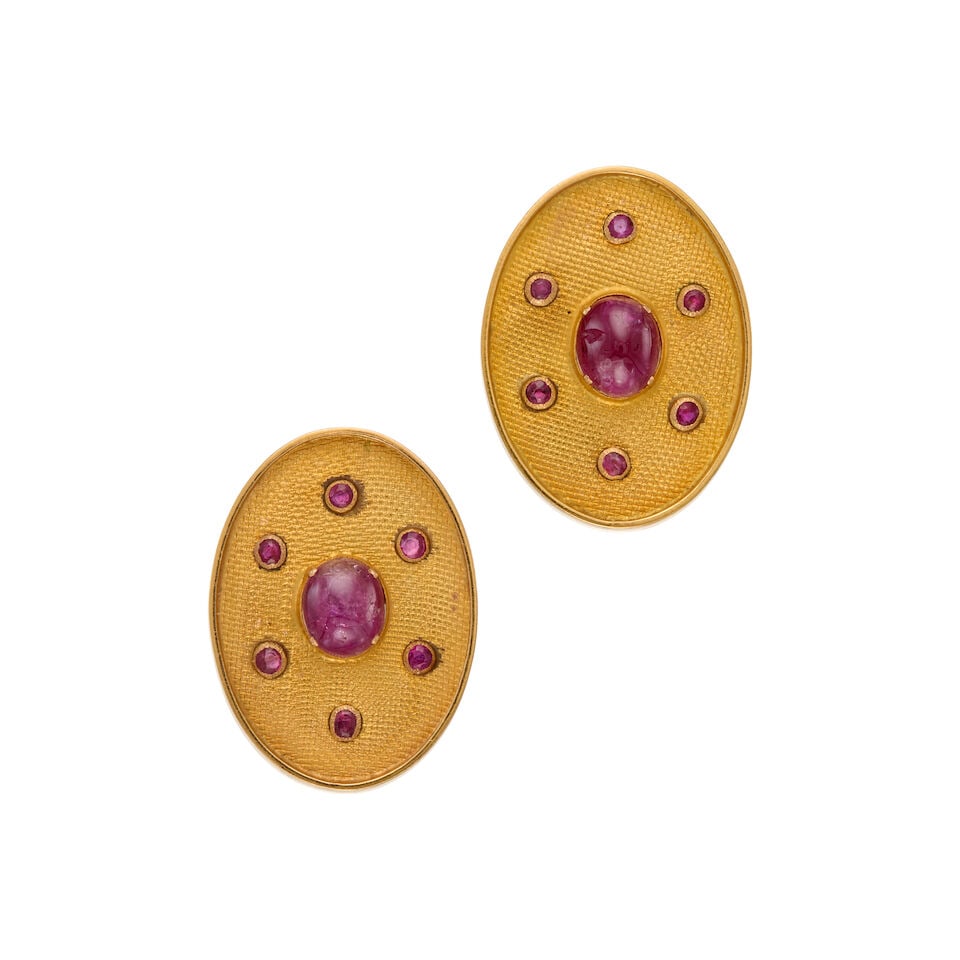 18K GOLD AND RUBY EARRINGS: 18K GOLD AND RUBY EARRINGS • Two oval cabochon rubies weighing approximately 5.24 carats total • Twelve round shaped rubies weighing approximately 0.60 carat total • Measures 1 1/4 i