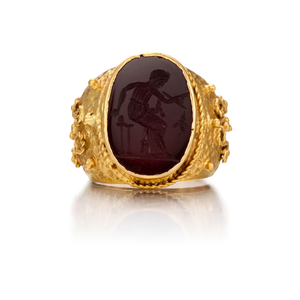 22K GOLD AND CARNELIAN INTAGLIO SIGNET RING: 22K GOLD AND CARNELIAN INTAGLIO SIGNET RING • One oval carved shaped carnelian measuring approximately 18.62mm x 12.74mm x dept is not available due to close back setting • Size 7 3/4