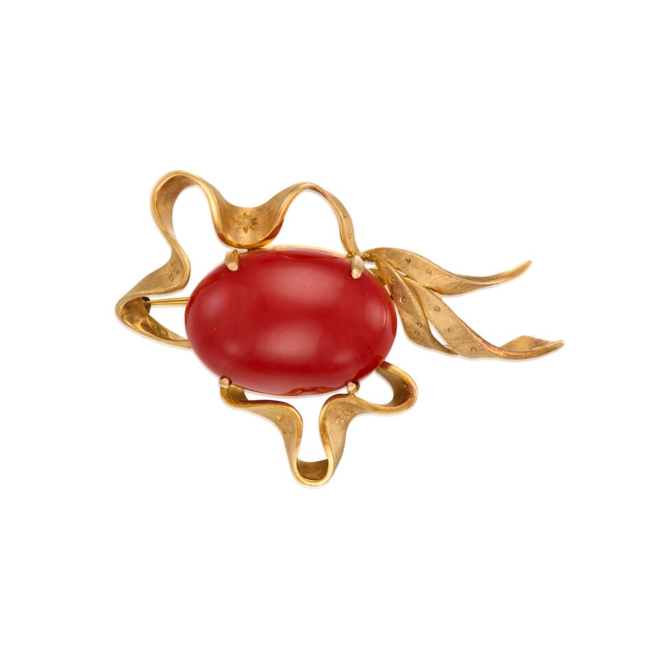 14K YELLOW GOLD AND CORAL BROOCH: 14K YELLOW GOLD AND CORAL BROOCH • An oval shaped cabochon coral measuring approximately 83.30mm x 20.91mm x 9.60mm • Measures 2 1/2 in. x 1 3/4 in. • Estimated gross weight: 23.4