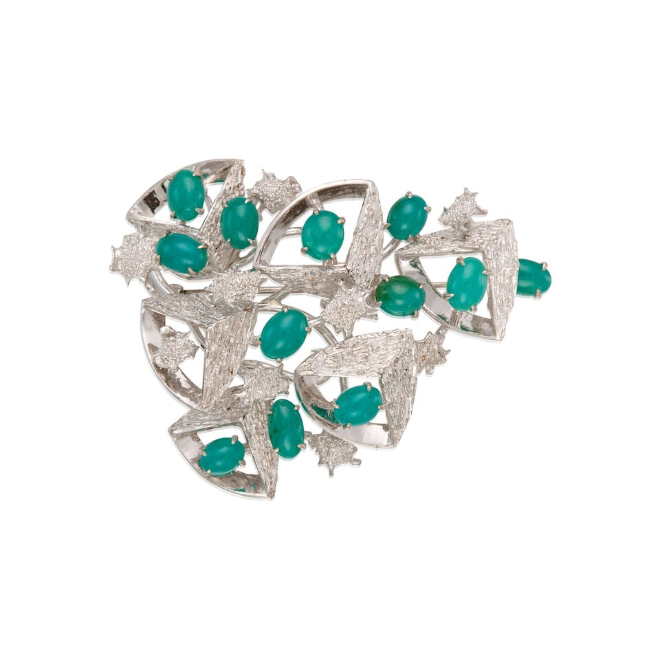 GEM SILICA BROOCH: GEM SILICA BROOCH • 9K white gold brooch and nickel-based metal clasp • Twelve oval cabochon shaped gem silica measuring approximately 7.38mm x 5.20mm x 2.76mm • Measures 2 1/2 in.
