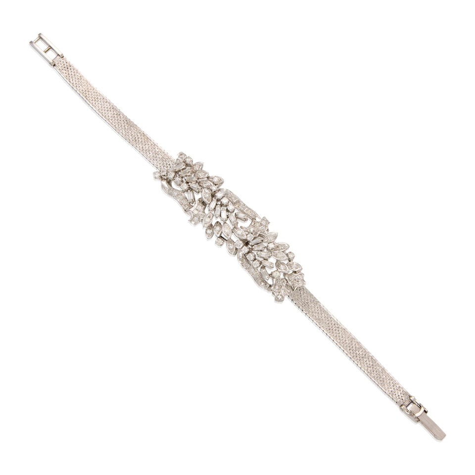 A SILVER AND DIAMOND BRACELET: A SILVER AND DIAMOND BRACELET • Numerous rectangular shaped diamonds weighing approximately 0.60 carat total • Numerous round shaped diamonds weighing approximately 0.80 carat total