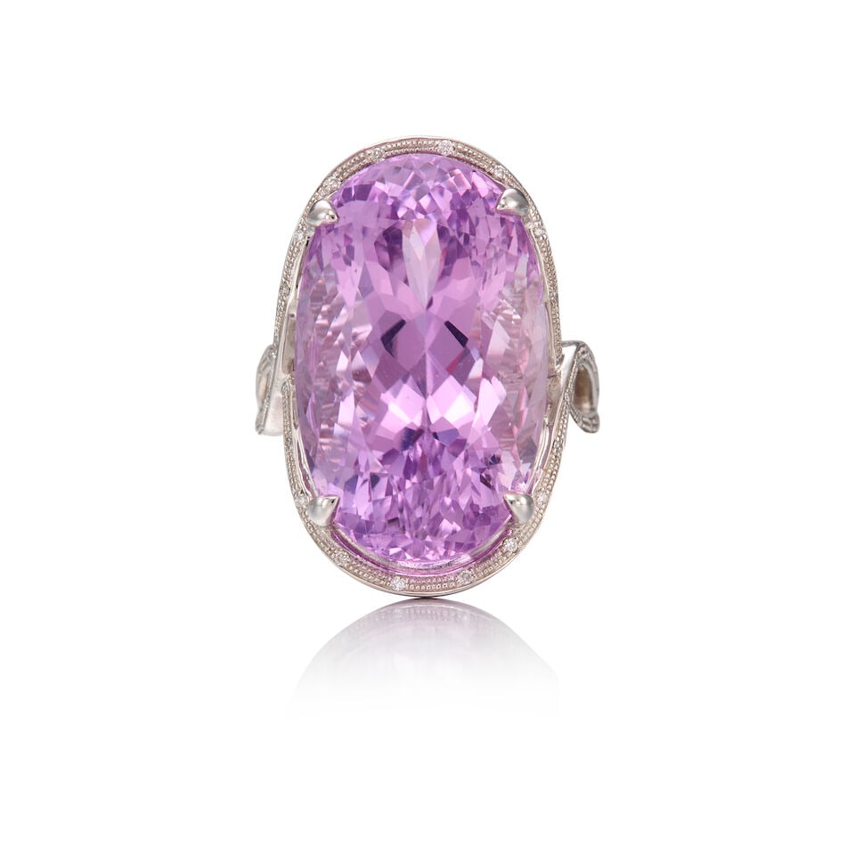 14K WHITE GOLD, KUNZITE, AND DIAMOND RING: 14K WHITE GOLD, KUNZITE, AND DIAMOND RING • An oval shaped kunzite weighing approximately 32 carats • Numerous melee diamonds • Size 7 • Estimated gross weight: 15.9