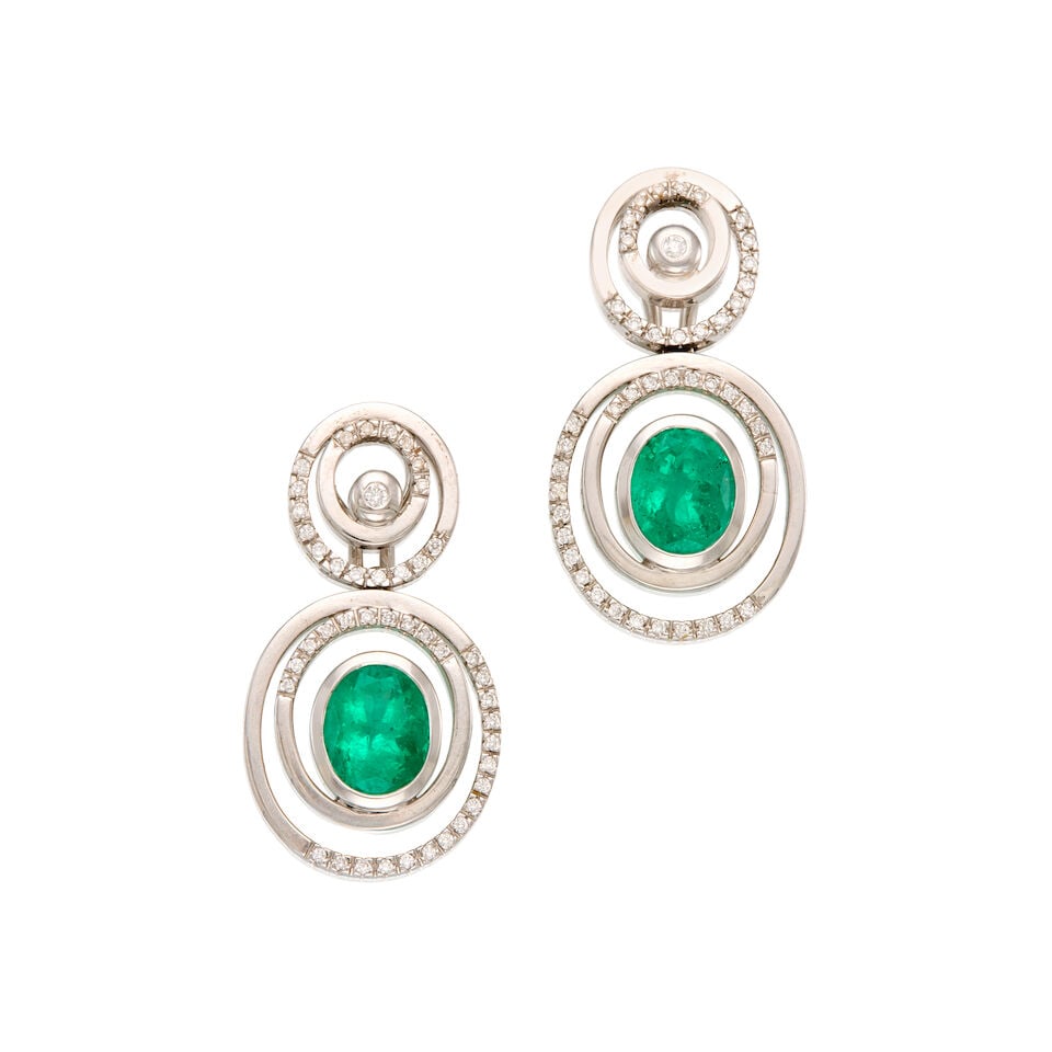 18K WHITE GOLD, EMERALD, AND DIAMOND DROP EARRINGS: 18K WHITE GOLD, EMERALD, AND DIAMOND DROP EARRINGS • Two oval shaped emeralds weighing approximately 4.40 carats total • Eighty-eight round brilliant cut diamonds weighing approximately 0.