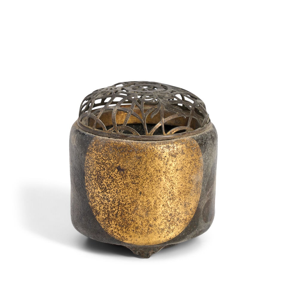 A Ceramic and Lacquer Incense Burner Japan, late Edo period (1615-1868),: A Ceramic and Lacquer Incense Burner Japan, late Edo period (1615-1868), Black-glazed stoneware with gold lacquer decoration and a metal openwork cover 3 3/4in (9.5cm) high overall For further informa