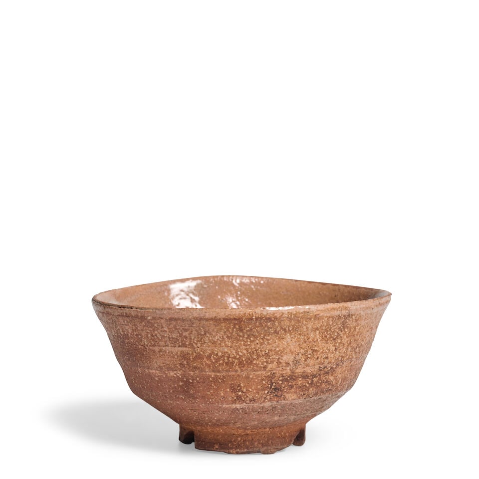A Stoneware Chawan (Tea Bowl) Japan, Showa (1926-1989) or Heisei (1989-2019) era, late 20th cent...: A Stoneware Chawan (Tea Bowl) Japan, Showa (1926-1989) or Heisei (1989-2019) era, late 20th century, Covered in a pinkish glaze, with a wood tomobako 3in (7.7cm) high Lot to be sold without reserve. T