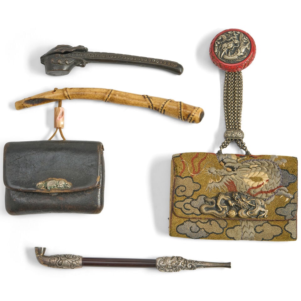 Four Smoking Accessories Japan, Meiji era (1868-1912), (4): Four Smoking Accessories Japan, Meiji era (1868-1912), A tobacco pouch with a silver dragon clasp; a tobacco pouch with a pipe case; a dragon-form yatate; and a pipe with dragon motifs. 8 1/2in (21.6c