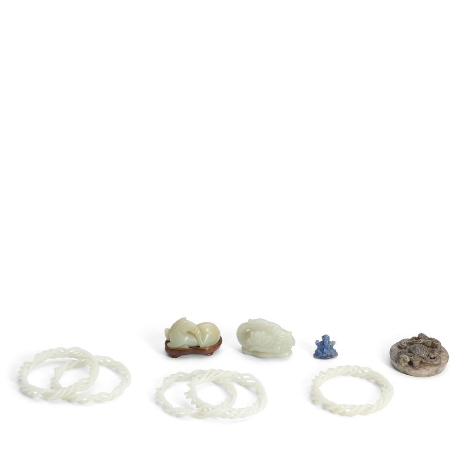 A Group of Nine Jade, Hardstone, and Carved Stone Items China, 20th century, (9): A Group of Nine Jade, Hardstone, and Carved Stone Items China, 20th century, A small jade recumbent horse; a goose on a lotus pad; a disc-form archaistic jade pommel; five celadon-color jade substitut