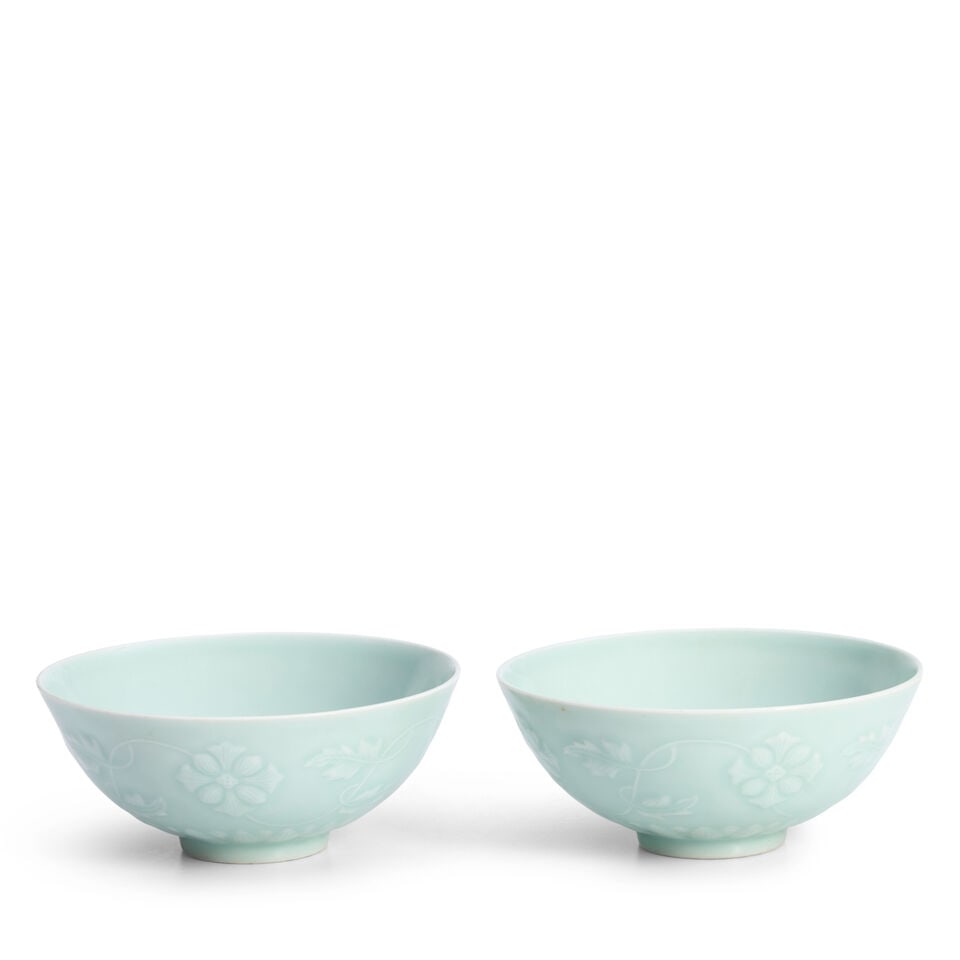A Pair of Celadon-glazed Bowls China, Yongzheng marks, 20th century, (2): A Pair of Celadon-glazed Bowls China, Yongzheng marks, 20th century, The exterior with slip-decorated mallow flowers and vines 5in (12.7cm) diam (2). Footnotes: Provenance: Property from the Collectio