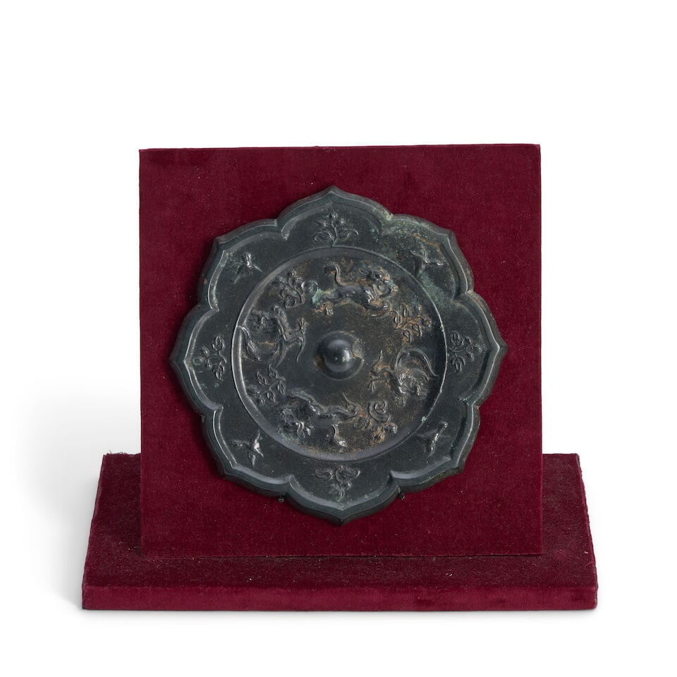 A Silvered Bronze 'Lion and Phoenix' Foliate-Rimmed Mirror Tang dynasty style, 20th century, - 2