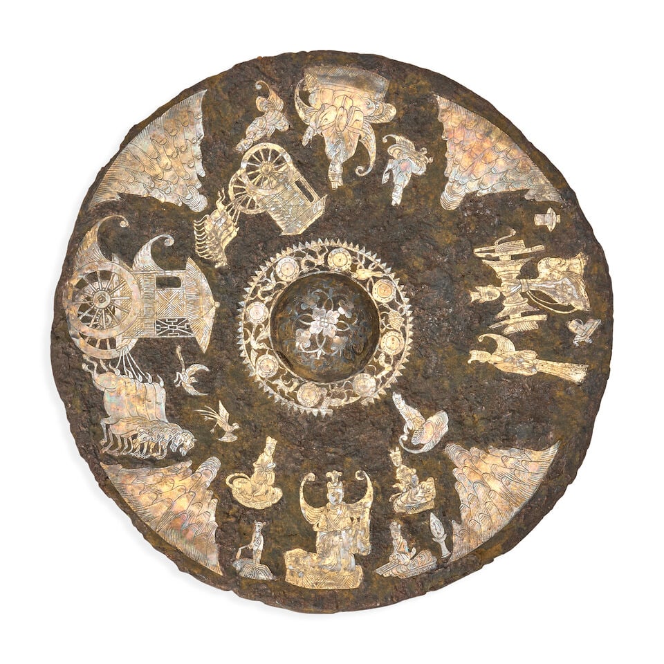 An Inlaid Cast Iron Mirror China, Han/Tang dynasty style, 20th century,: An Inlaid Cast Iron Mirror China, Han/Tang dynasty style, 20th century, 10 1/4in (26cm) diam Footnotes: Provenance: Property from the Collection of Alan and Simone Hartman This lot is subject to the
