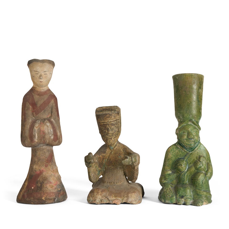 A Group of Three Pottery Figures China, Han dynasty style, 20th century, (3): A Group of Three Pottery Figures China, Han dynasty style, 20th century, A standing female attendant; a seated musician; and a green-glazed mother and child lamp with cupped holder on her head 7 1/2in