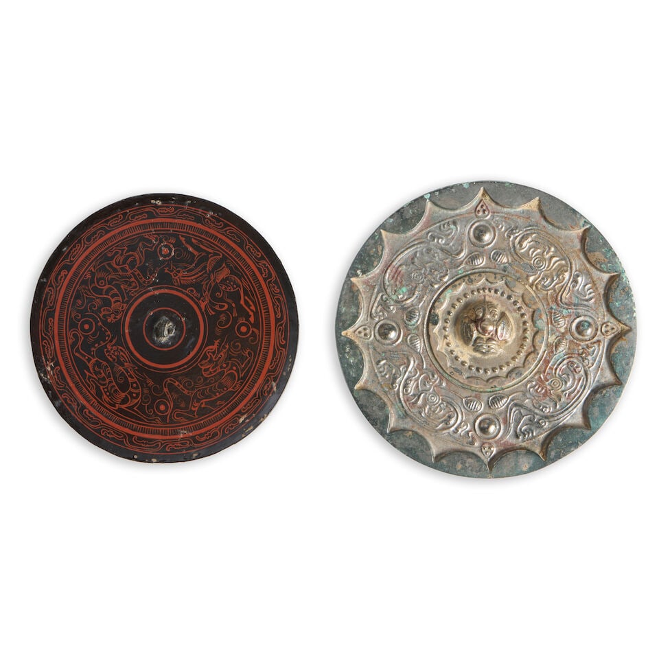 Two Bronze Mirrors China, Han dynasty style, 20th century, (2): Two Bronze Mirrors China, Han dynasty style, 20th century, A silvered bronze mirror with archaistic creatures; and a lacquered bronze mirror with red-painted dragons and other mythical creatures and t