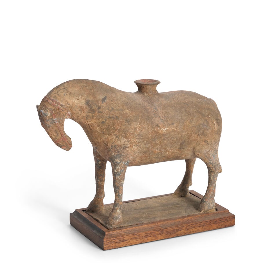 A Pottery Horse China, Northern Wei-style, 20th century,: A Pottery Horse China, Northern Wei-style, 20th century, The horse standing squarely with its head lowered, with an opening in the middle of its back 7 1/2in(19.1cm) high Footnotes: Provenance: Proper