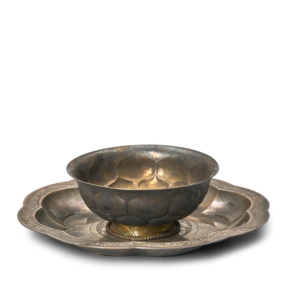 A Silver Lobed Tray and A Parcel-gilt Footed Bowl China, Tang dynasty style, 20th century, (2): A Silver Lobed Tray and A Parcel-gilt Footed Bowl China, Tang dynasty style, 20th century, The lobed tray with chased peony motif; the bowl with lotus lappets containing birds and animals 9 1/4in (23.