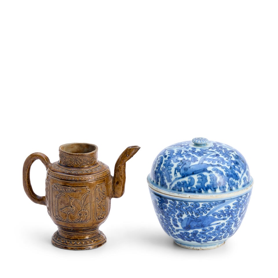 A Blue and White Covered Bowl and a Brown-glazed Ewer China, 18th/19th century, (2): A Blue and White Covered Bowl and a Brown-glazed Ewer China, 18th/19th century, The bowl decorated with galloping horses amid foliage; the ewer with crane and deer motifs in relief 5 1/4in (13.3cm); 4