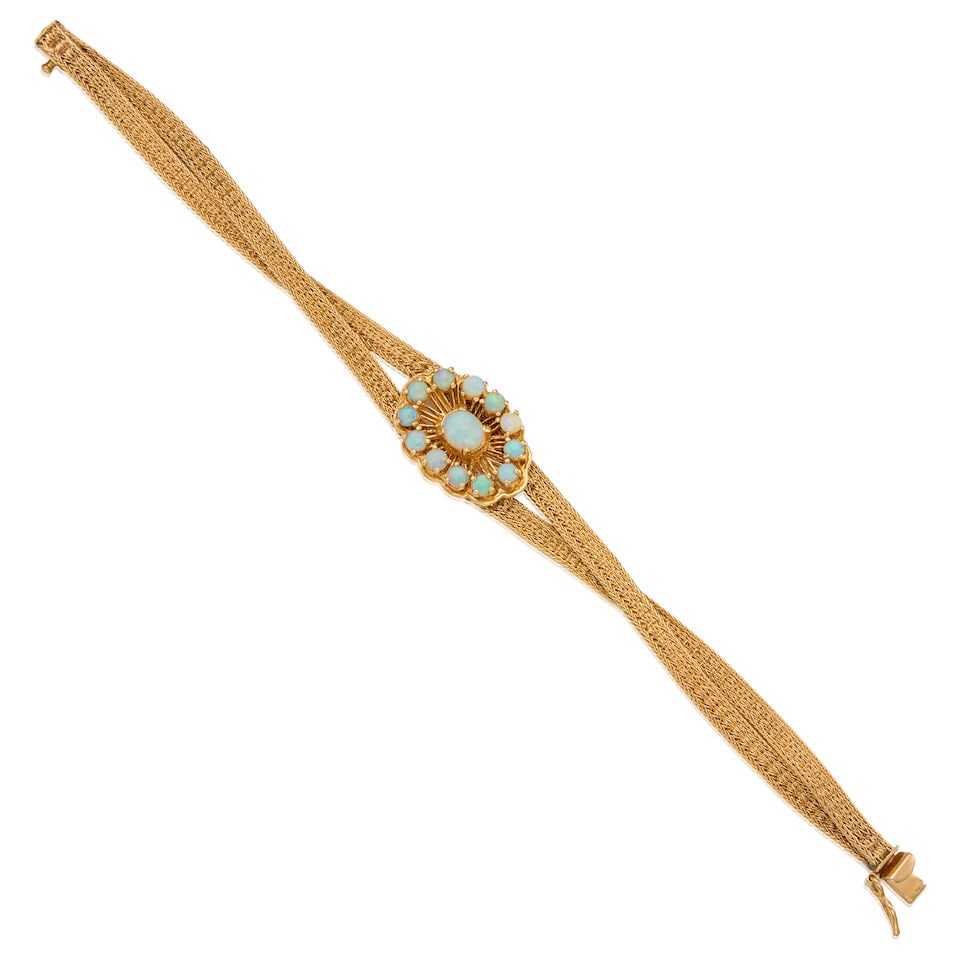 14K GOLD AND OPAL BRACELET: 14K GOLD AND OPAL BRACELET • One oval cabochon opal measuring approximately 6.26mm x 5.27mm x 3.92mm and twelve round shaped cabochon opals measuring approximately 2.86mm in diameter •