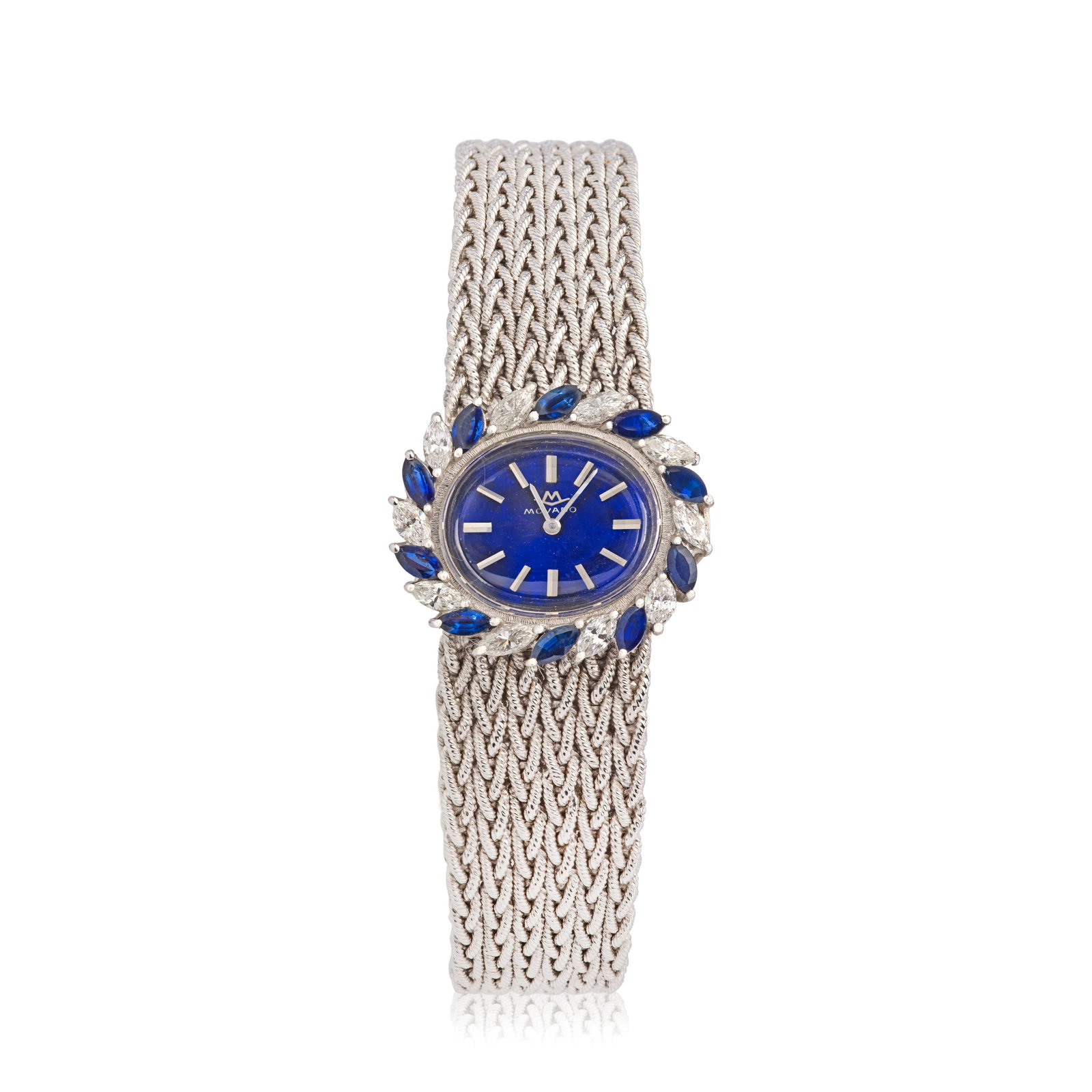 Movado. A lady's 18K white gold diamond and sapphire set manual wind oval bracelet watch Circa 1970: Movado. A lady's 18K white gold diamond and sapphire set manual wind oval bracelet watch Date: Circa 1970 Movement: 17-jewel Cal.E3 manual wind Dial: Blue, applied polished and faceted baton hour mark