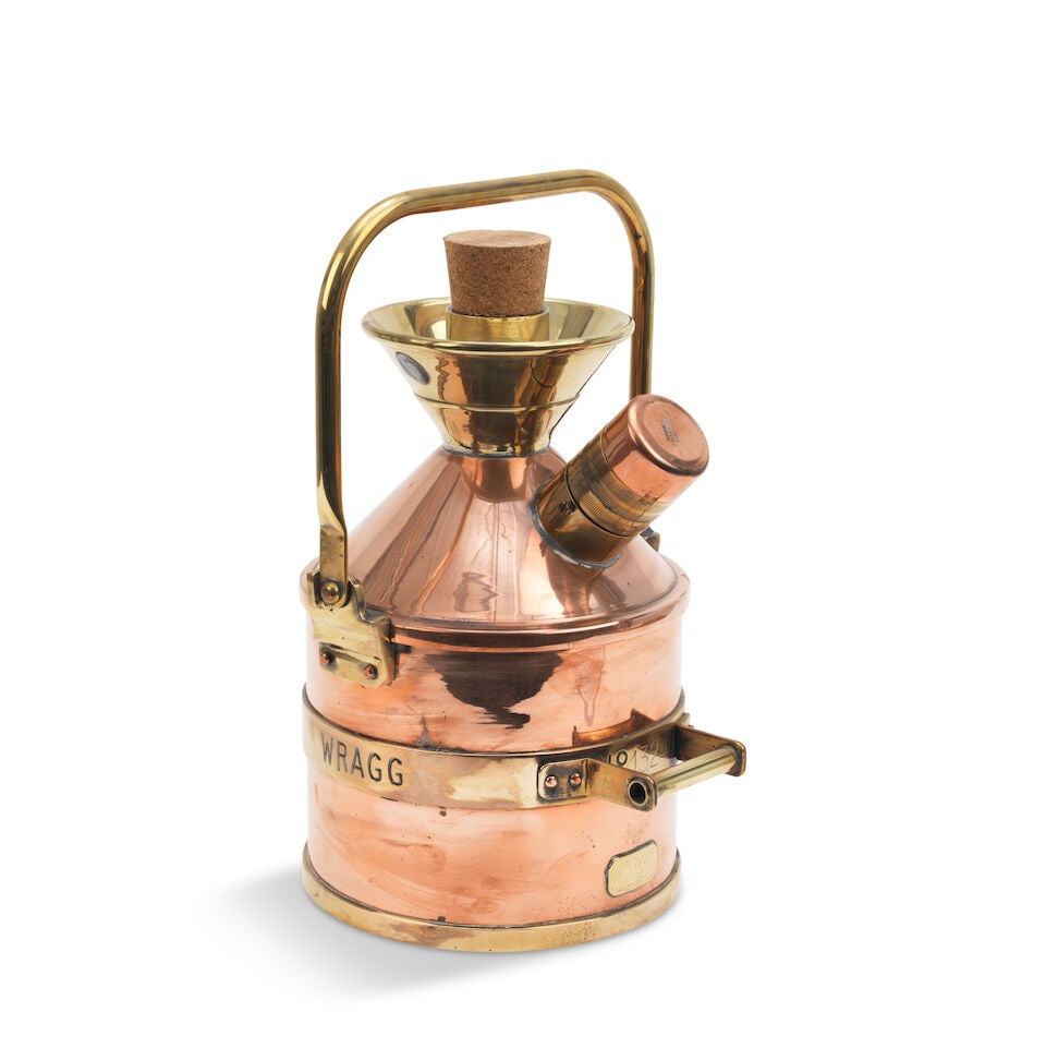 A Wragg Brothers 5-Litre petrol measure,: A Wragg Brothers 5-Litre petrol measure, number 1324 marked 'In 20˚C', polished brass and copper construction, cylindrical with conical top, with replaced cork bung, with loop handle 38 cm high o