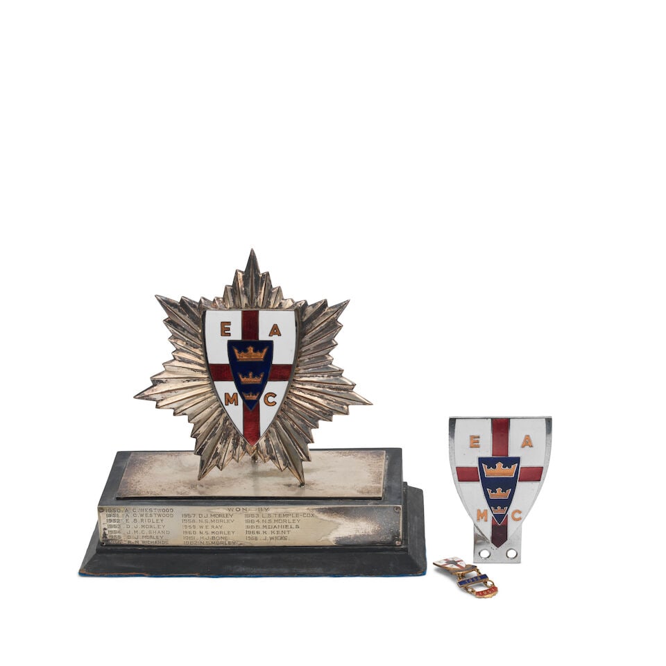 An East Anglian Motor Club member's badge, 1950s, ((3)): An East Anglian Motor Club member's badge, 1950s, chromed, shield-shaped in four colour enamel, 9cm high (some red enamel lifted), together with a matching lapel badge for Butlin's Rally with 1950 and