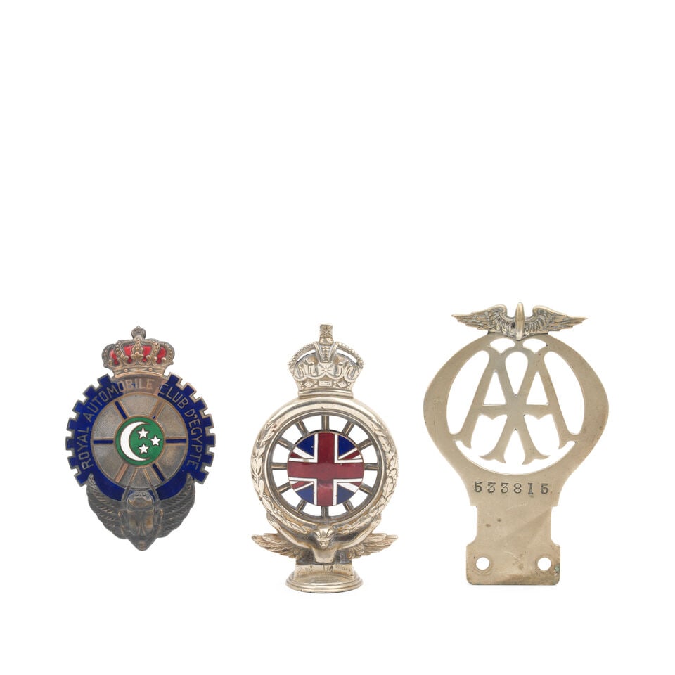 A Royal Automobile Club D'Egypt enamelled car badge, ((3)): A Royal Automobile Club D'Egypt enamelled car badge, single-sided brass badge enamelled in four colours, featuring cog design with crown, crescent and stars centre, and scarab emblem, some loss to