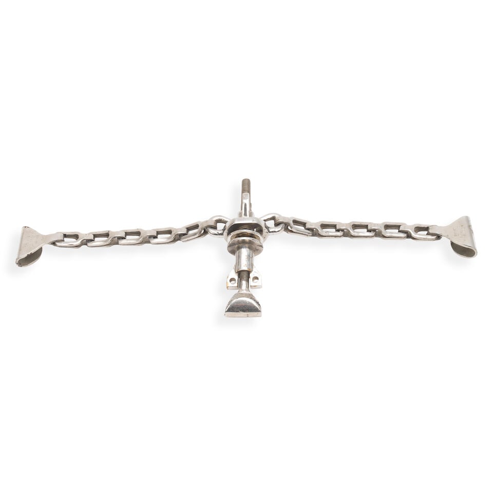 A chained securing bracket, to suit a vintage Louis Vuitton car trunk,: A chained securing bracket, to suit a vintage Louis Vuitton car trunk, polished nickel, main threaded bolt with upper clip, with two heavy-link side chains fitted with clips marked 'Louis Vuitton Depo