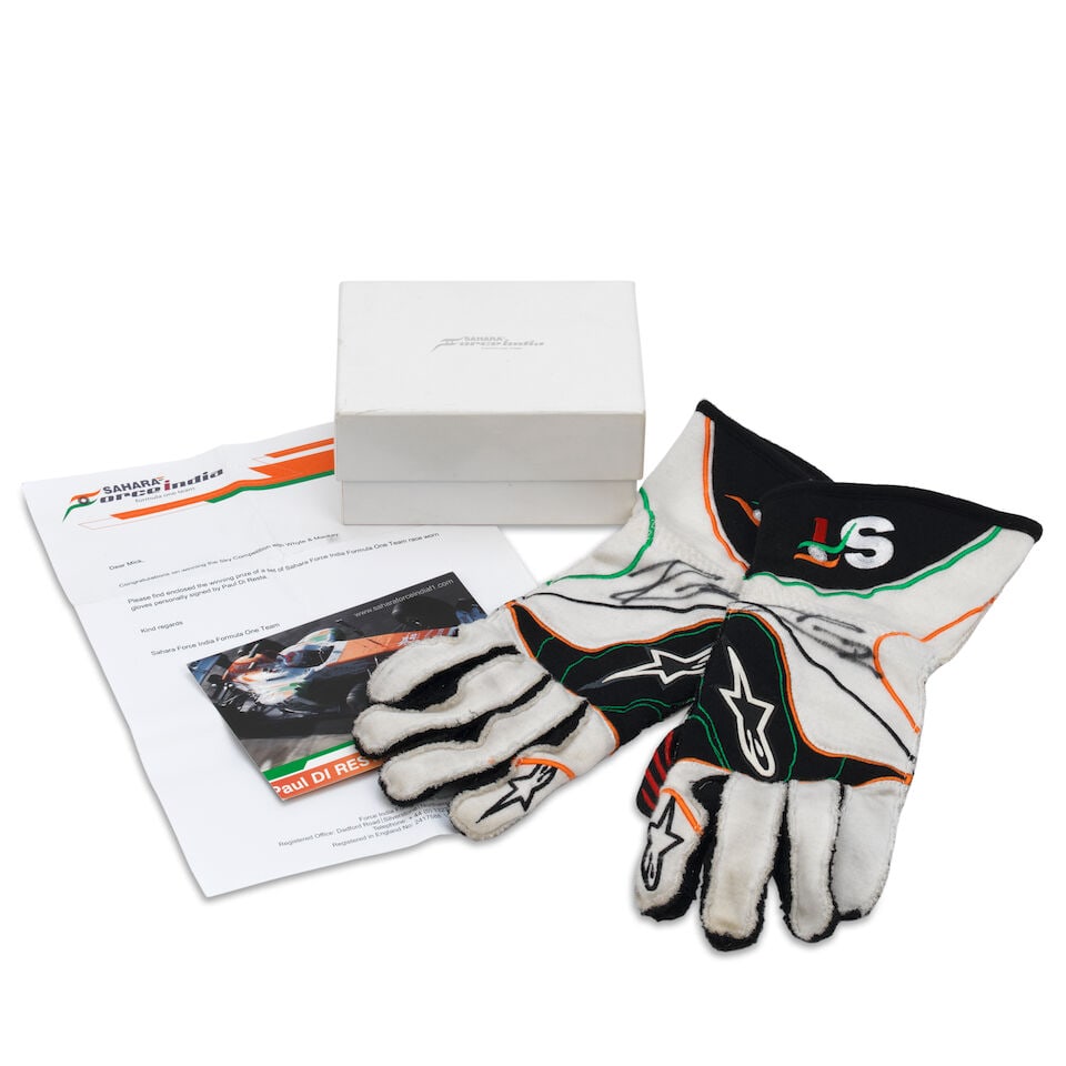 A signed pair of used Paul Di Resta Sahara Force India F1 gloves,: A signed pair of used Paul Di Resta Sahara Force India F1 gloves, in team colours, both signed in black marker, with sponsors logos, wear from use, offered in a team branded box, with a signed driver