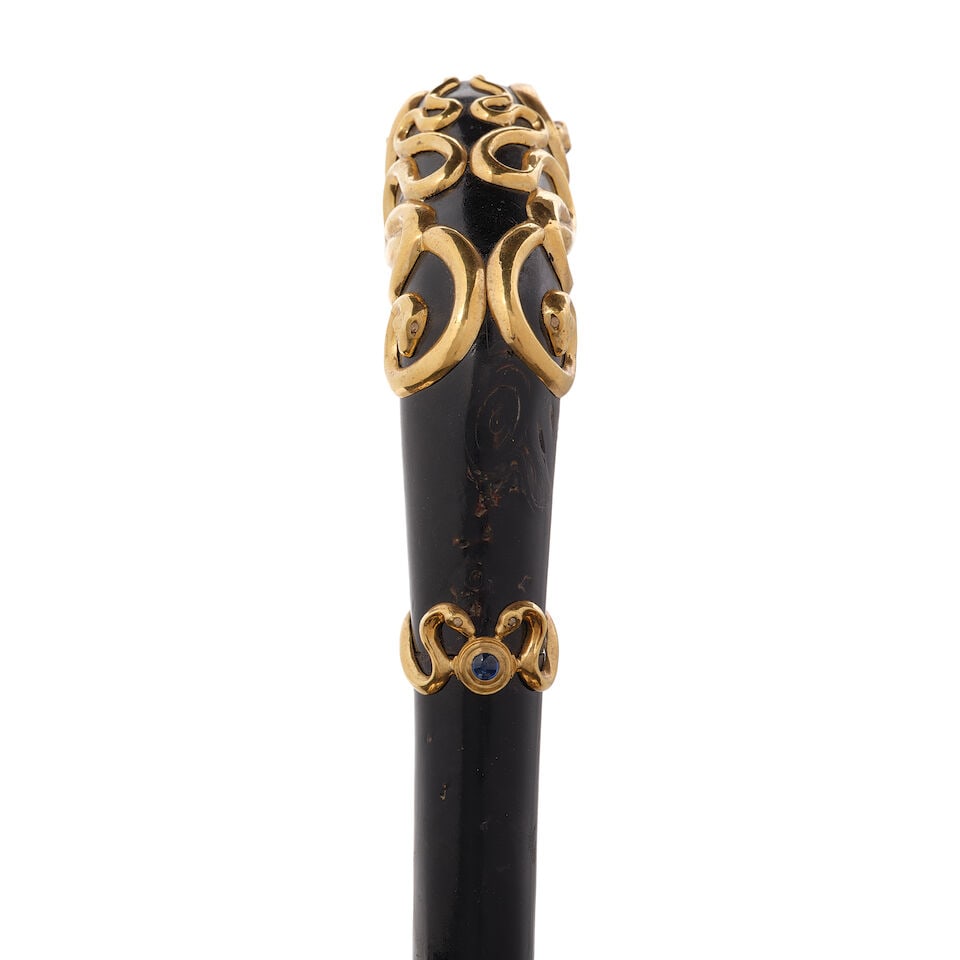 A CONTINENTAL DIAMOND AND SAPPHIRE INSET 18K GOLD OVERLAID BLACK CORAL SNAKE CANEPossibly French... - 2