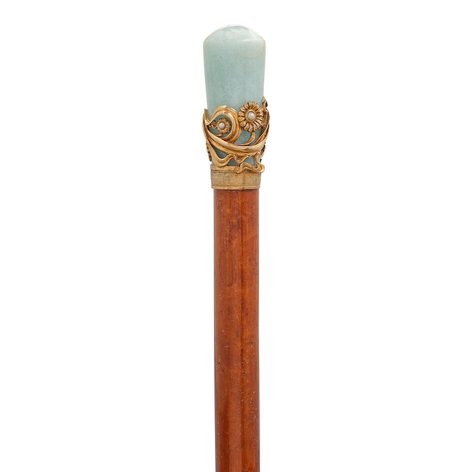 A RUSSIAN AQUAMARINE AND PEARL INSET 875 SILVER-GILT STIL MODERN FLOWER CANECirca 1890: A RUSSIAN AQUAMARINE AND PEARL INSET 875 SILVER-GILT STIL MODERN FLOWER CANE Circa 1890 The aquamarine milord handle enveloped by pearl inset silver-gilt flower and vine motif above a chassed silver-g