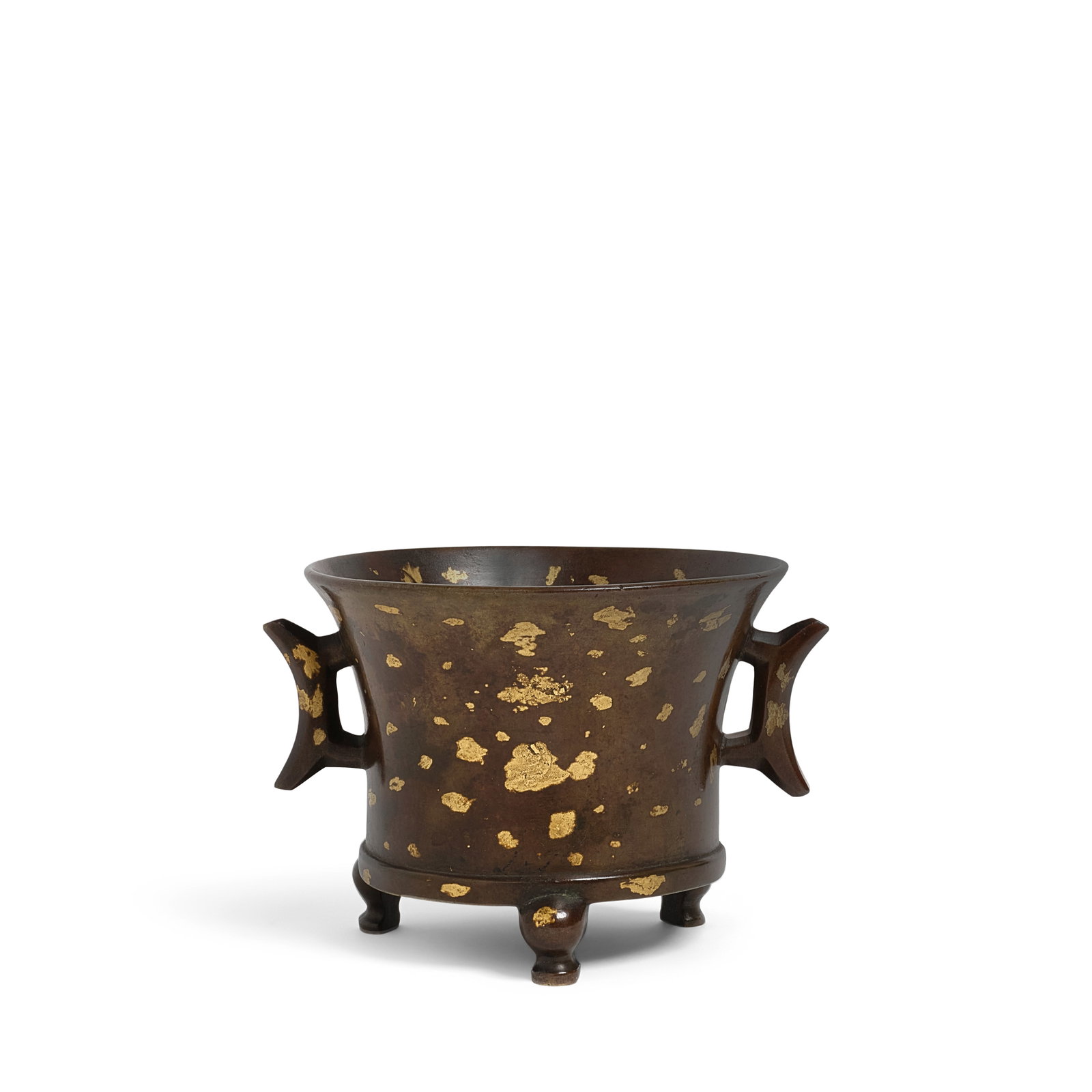A GOLD-SPLASHED BRONZE TRIPOD HANDLED CENSER Qing Dynasty: A GOLD-SPLASHED BRONZE TRIPOD HANDLED CENSER Qing Dynasty Finely cast of waisted cylindrical form with flaring mouth rim, supported on three short curving feet and flanked by a pair of crescent-moon h