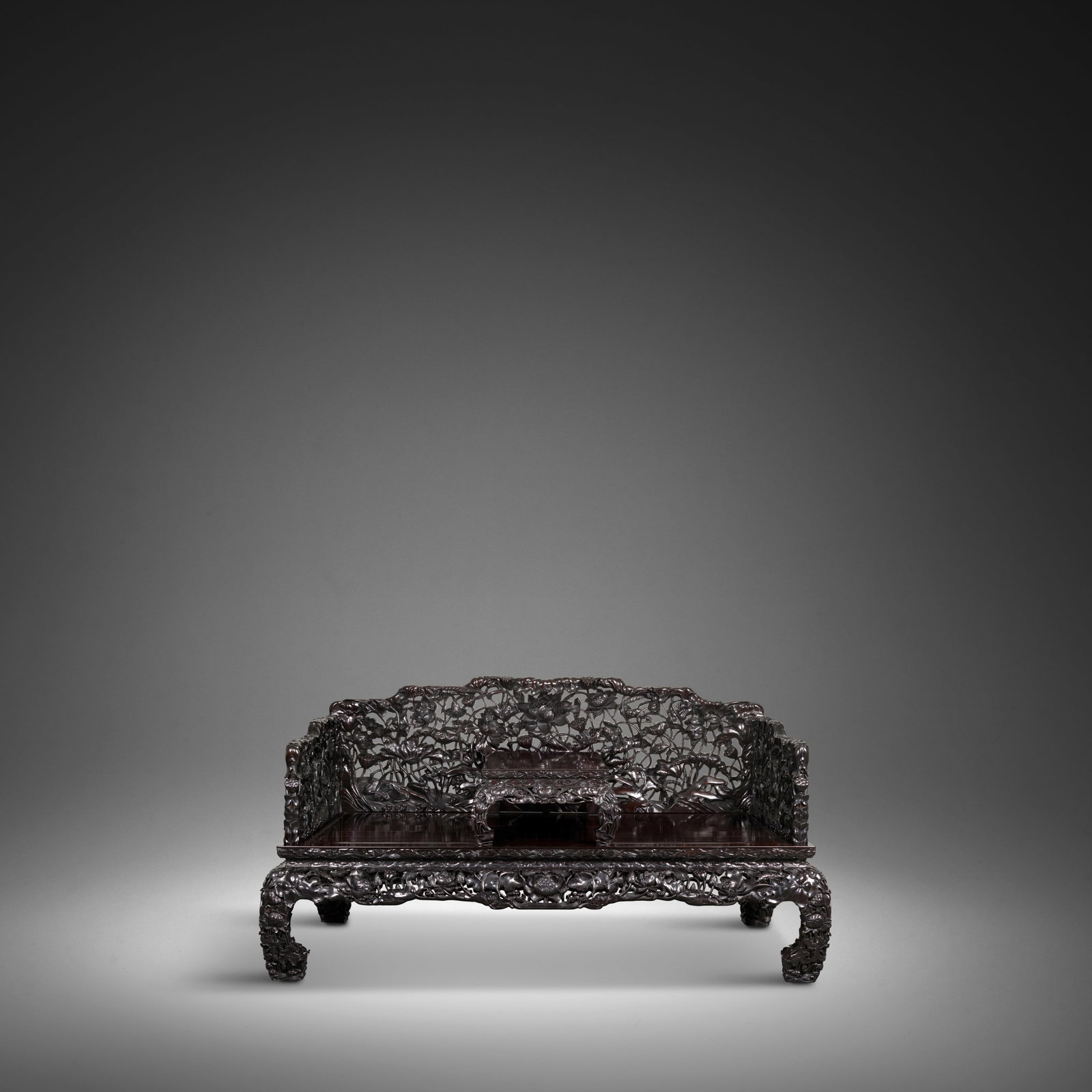 A RARE AND SPLENDID ZITAN 'LOTUS' LUOHAN BED AND KANG TABLE Qing Dynasty, 18th/19th century (2): A RARE AND SPLENDID ZITAN 'LOTUS' LUOHAN BED AND KANG TABLE Qing Dynasty, 18th/19th century The back and side panels carved to resemble a nine-part screen and superbly carved as a dense network of lot