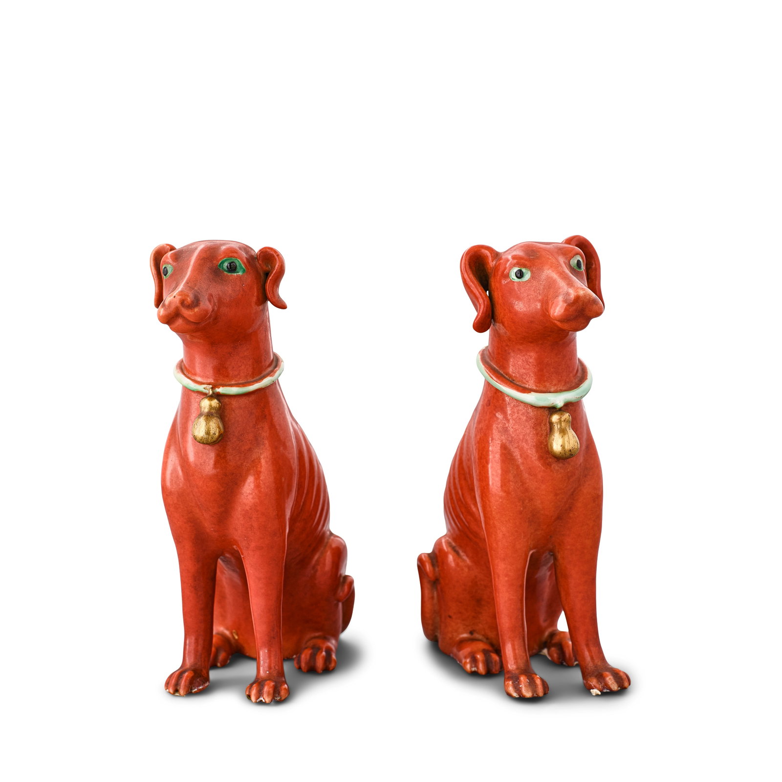 A PAIR OF FAMILLE-ROSE FIGURES OF HOUNDS 18th/early 19th century (2, wood stands): A PAIR OF FAMILLE-ROSE FIGURES OF HOUNDS 18th/early 19th century Each naturalistically moulded seated on its haunches, the bodies with rich iron-red coat, their eyes green, wearing a gilt bell suspend