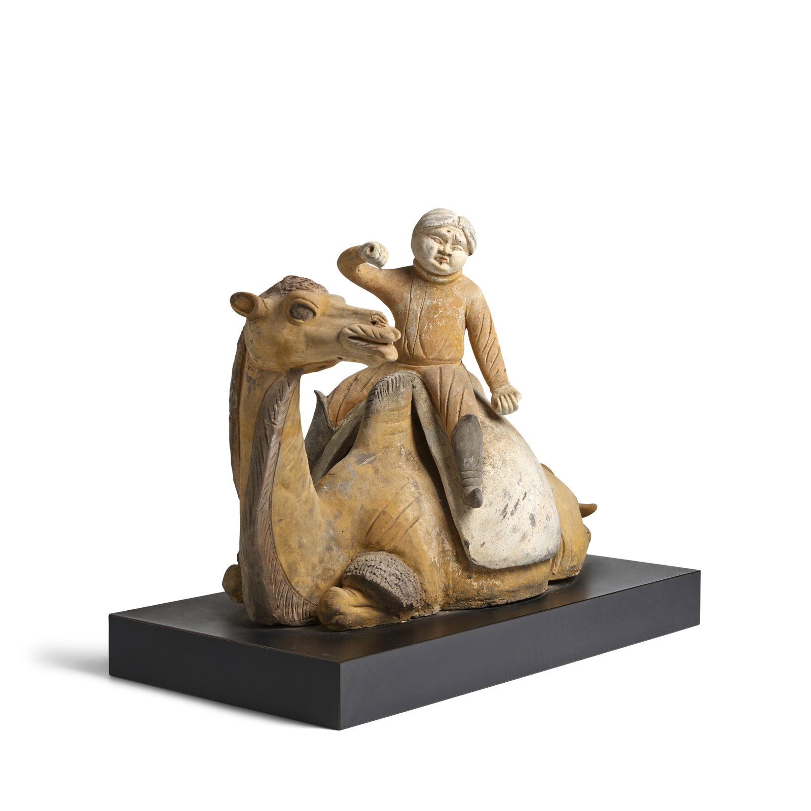 A PAINTED POTTERY RECUMBENT CAMEL AND RIDER Tang Dynasty (black stand) (1 of 1)