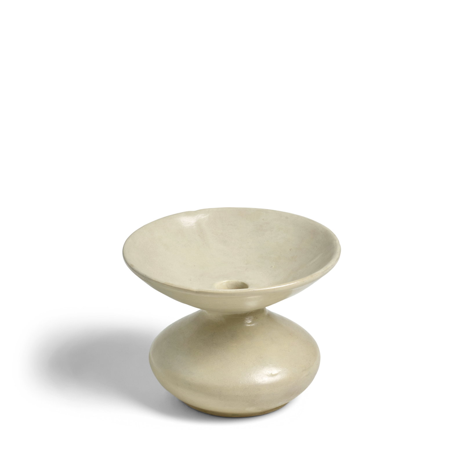 A WHITE-GLAZED SPITTOON, ZHADOU Late Tang/Five Dynasties: A WHITE-GLAZED SPITTOON, ZHADOU Late Tang/Five Dynasties The compressed globular body supported on short flat base, the waisted neck surmounting a wide flared mouth, covered inside and out in a creamy