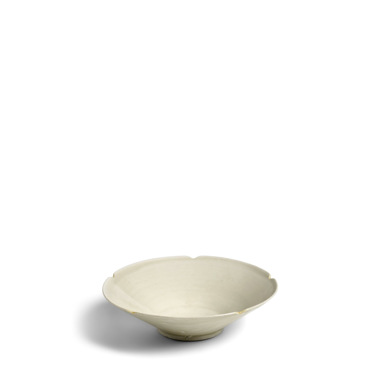 A DING WHITE-GLAZED FIVE-LOBED CONICAL BOWL Five Dynasties (brocade box): A DING WHITE-GLAZED FIVE-LOBED CONICAL BOWL Five Dynasties Rising from a short ring foot, the rim divided by five notches, covered inside and out with a translucent cream-white glaze pooling to darker