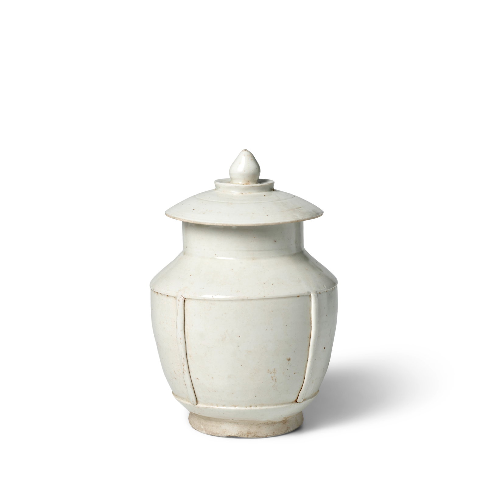 A DING-TYPE WHITE-GLAZED JAR AND COVER Northern Song Dynasty (purple brocade box): A DING-TYPE WHITE-GLAZED JAR AND COVER Northern Song Dynasty The cylindrical vessel slightly tapered, the indented mid-section divided into four panels by raised ribs and a 'ladder'-shaped decoration 