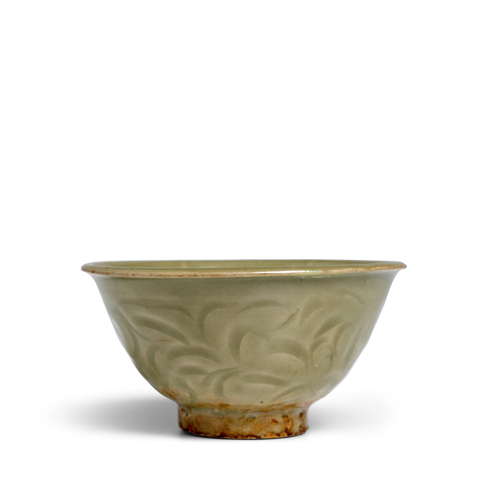 A SMALL CARVED YAOZHOU CELADON BOWL Northern Song Dynasty: A SMALL CARVED YAOZHOU CELADON BOWL Northern Song Dynasty Freely carved with a continuous floral design on the exterior, the interior wall with six radiating 'ribs' centering an indented base, covered