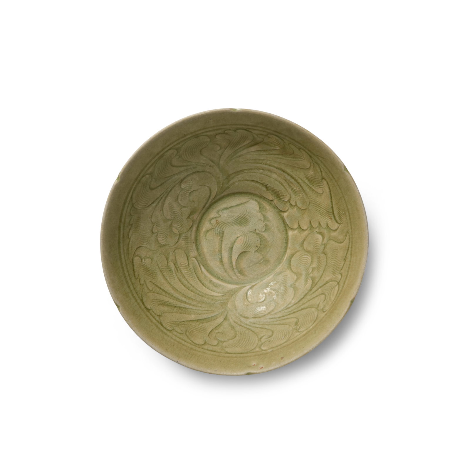 A CARVED LONGQUAN CELADON 'FOLIATE' BOWL Song Dynasty: A CARVED LONGQUAN CELADON 'FOLIATE' BOWL Song Dynasty The deep-rounded sides rising from the short ring foot to a notched rim, the interior decorated with two large foliate bundles within a double-rin
