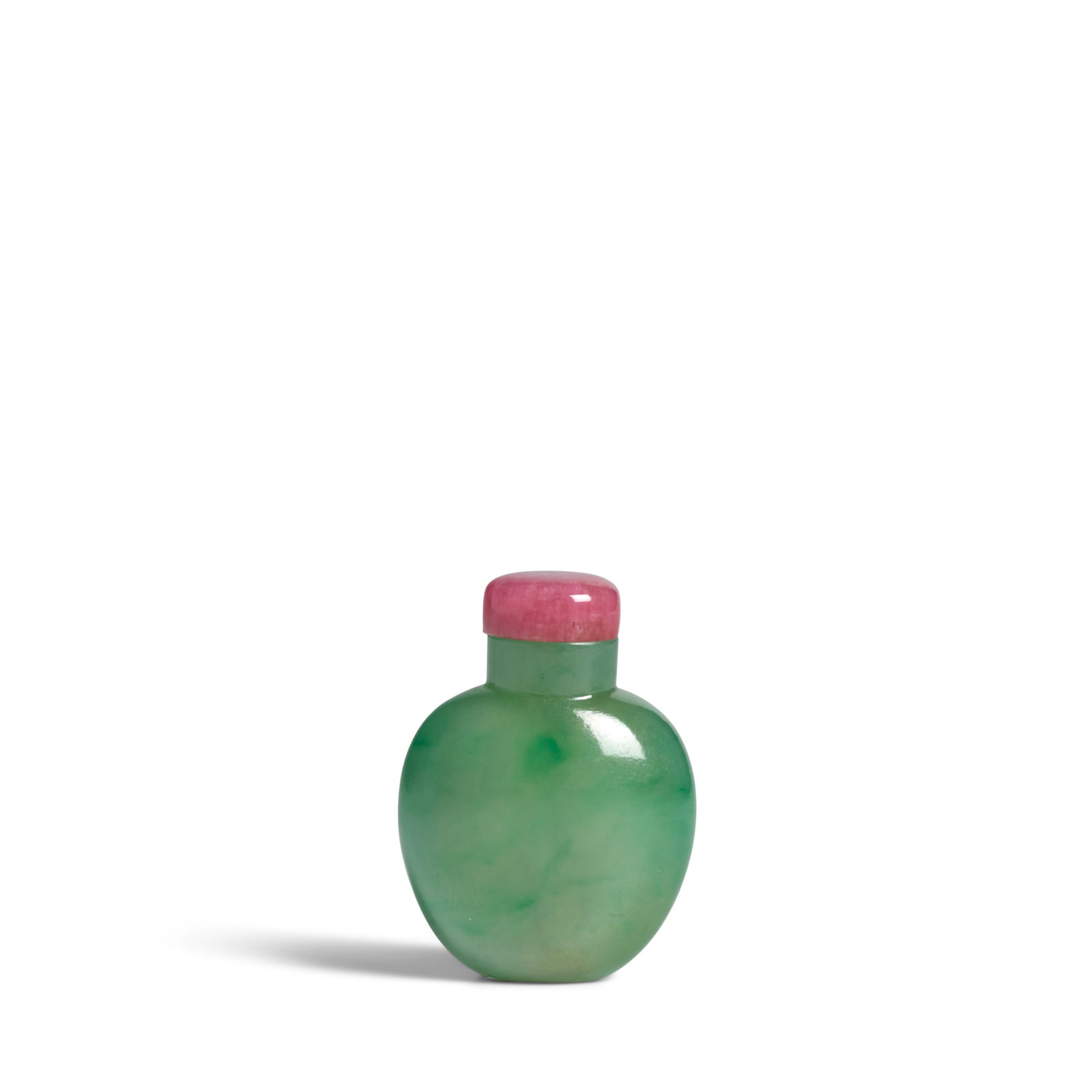 AN EMERALD GREEN-FLECKED JADEITE SNUFF BOTTLE 1820-1900: AN EMERALD GREEN-FLECKED JADEITE SNUFF BOTTLE 1820-1900 Of small, globular shape with circular neck, slightly concave rim and small mouth, the stone with emerald-green flecks throughout and flat oval 
