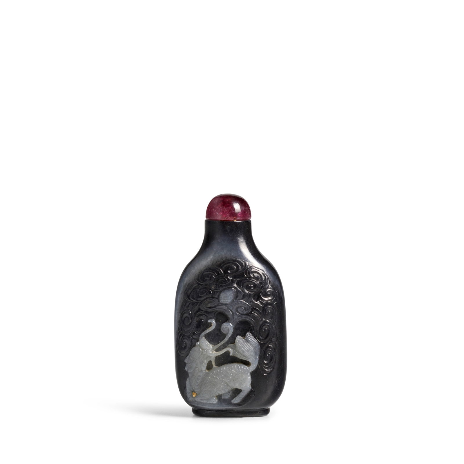 A FINE BLACK AND WHITE JADE SNUFF BOTTLE 1820-1880: A FINE BLACK AND WHITE JADE SNUFF BOTTLE 1820-1880 Of tapered rectangular form, carved to the front with a crouching bixie with mouth agape trying to reach a sacred book in the clouds above, the anima